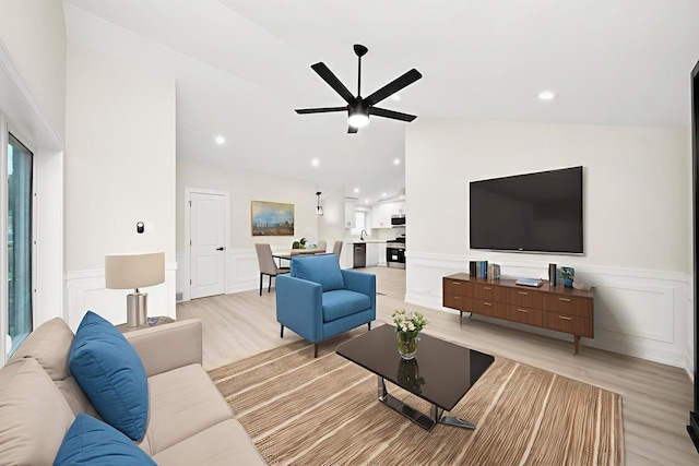 5246 S New England Ave, Chicago, IL 60638 - living room with light wood-style floors, wainscoting, ceiling fan, vaulted ceiling, and a decorative wall