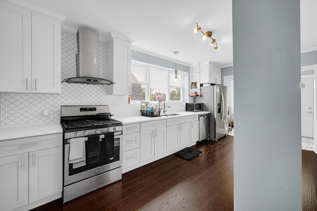 4125 W School St, Chicago, IL 60641 - kitchen featuring appliances with stainless steel finishes, wall chimney exhaust hood, crown molding, dark wood finished floors, and tasteful backsplash