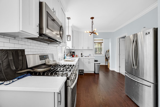4125 W School St, Chicago, IL 60641 - kitchen featuring stainless steel appliances, a chandelier, dark wood-style floors, decorative backsplash, and ornamental molding