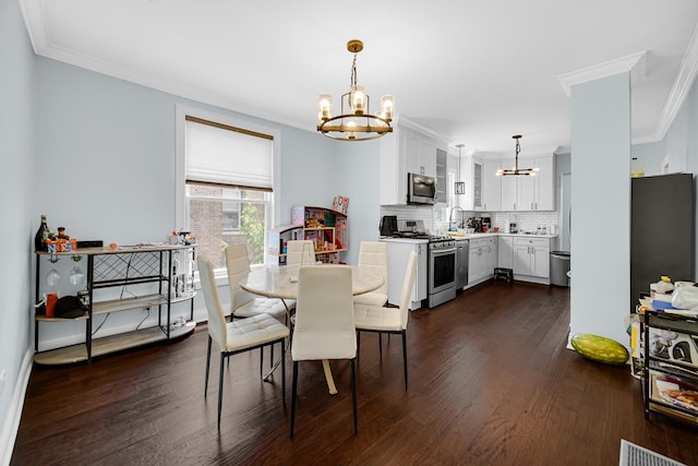 4125 W School St, Chicago, IL 60641 - dining space featuring a chandelier, crown molding, and dark wood-type flooring