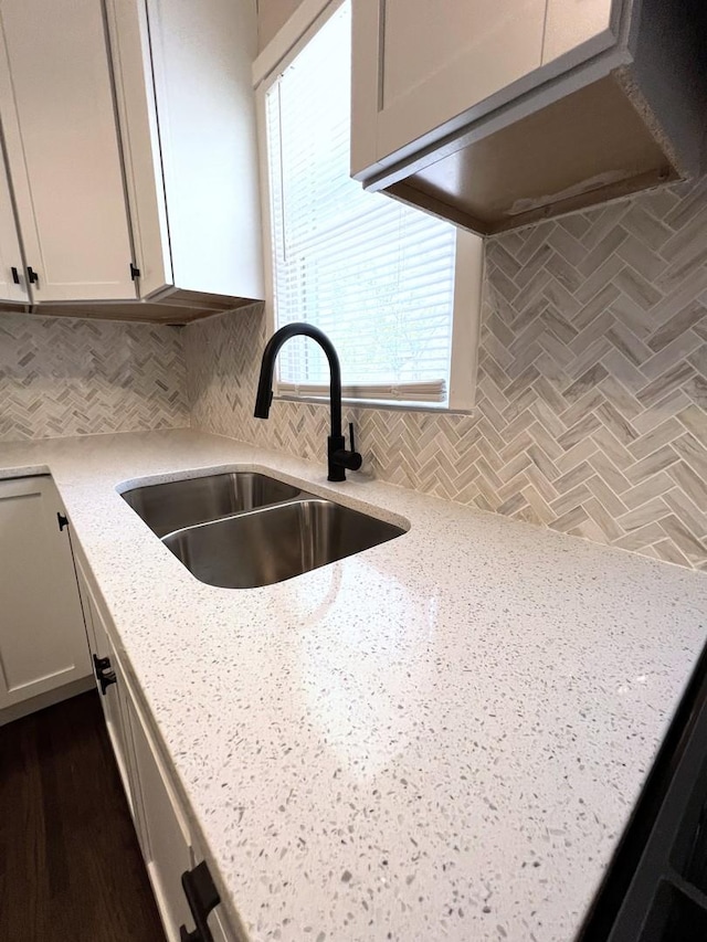 120 S May St, Joliet, IL 60436 - kitchen featuring light stone counters, backsplash, and white cabinetry
