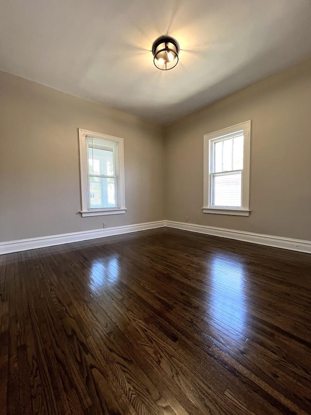 120 S May St, Joliet, IL 60436 - unfurnished room featuring baseboards and dark wood finished floors