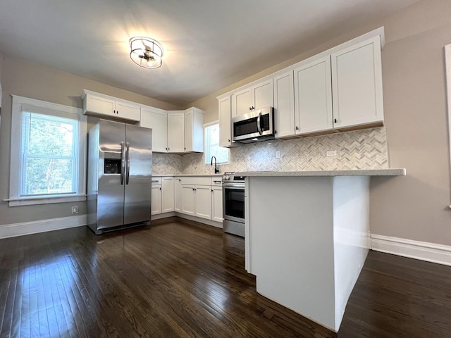 120 S May St, Joliet, IL 60436 - kitchen with stainless steel appliances, light countertops, and dark wood-type flooring