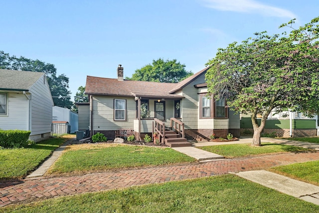 607 E Bridge St, Streator, IL 61364 - view of front of house with a chimney, a front yard, and roof with shingles