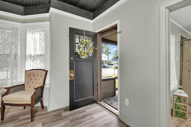 607 E Bridge St, Streator, IL 61364 - foyer entrance featuring crown molding, wood finished floors, and a decorative wall
