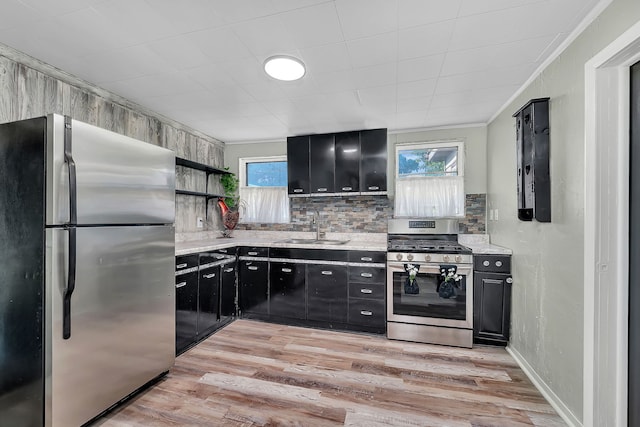 607 E Bridge St, Streator, IL 61364 - kitchen with appliances with stainless steel finishes, dark cabinets, and healthy amount of natural light