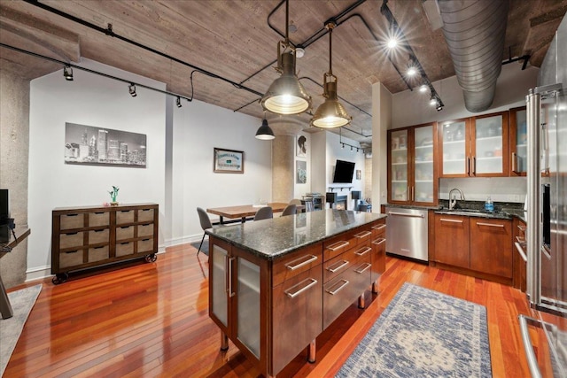 411 W Ontario St Unit 411, Chicago, IL 60654 - kitchen with dishwasher, light wood finished floors, track lighting, and glass insert cabinets