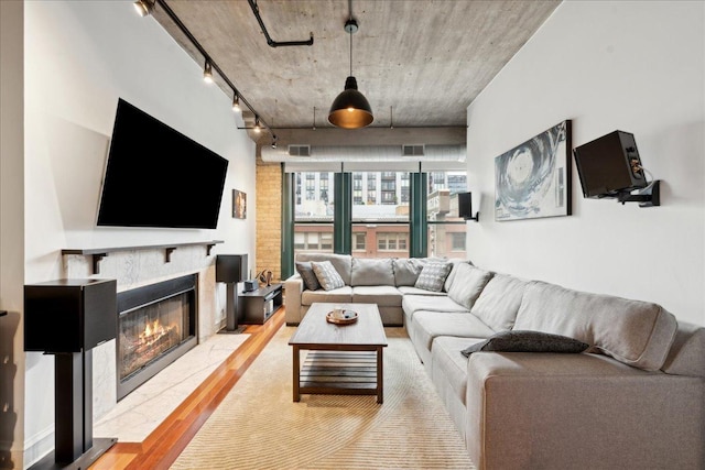 411 W Ontario St Unit 411, Chicago, IL 60654 - living room featuring rail lighting, light wood finished floors, and a fireplace