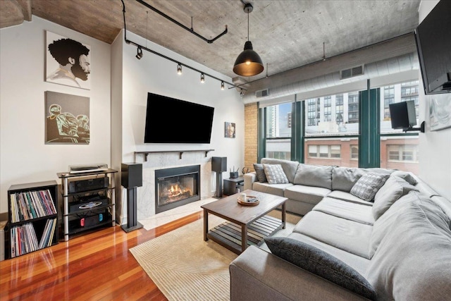 411 W Ontario St Unit 411, Chicago, IL 60654 - living room featuring plenty of natural light, wood finished floors, a fireplace, and track lighting