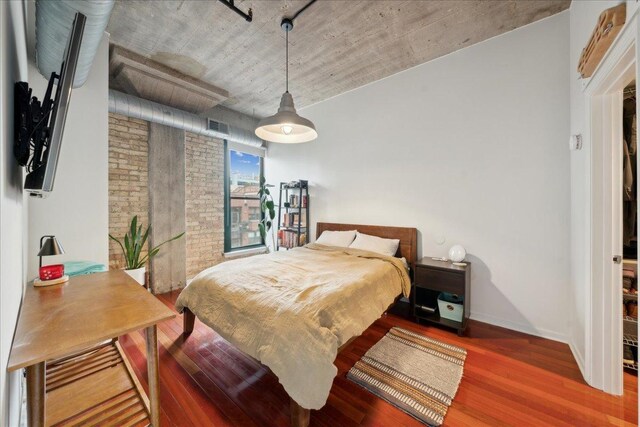 411 W Ontario St Unit 411, Chicago, IL 60654 - bedroom with wood finished floors and brick wall