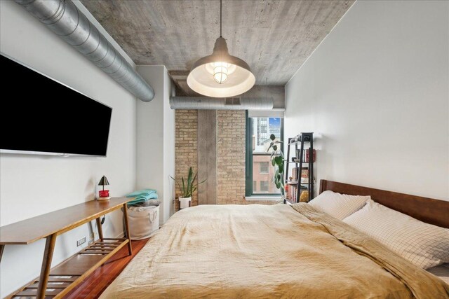411 W Ontario St Unit 411, Chicago, IL 60654 - bedroom featuring wood finished floors and brick wall
