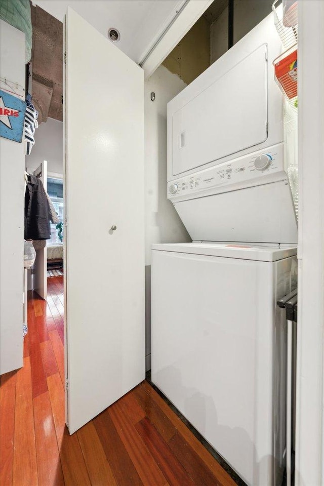411 W Ontario St Unit 411, Chicago, IL 60654 - laundry area featuring stacked washing machine and dryer and wood-type flooring