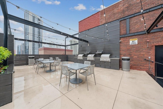 411 W Ontario St Unit 411, Chicago, IL 60654 - view of patio featuring area for grilling, outdoor dining area, and a city view