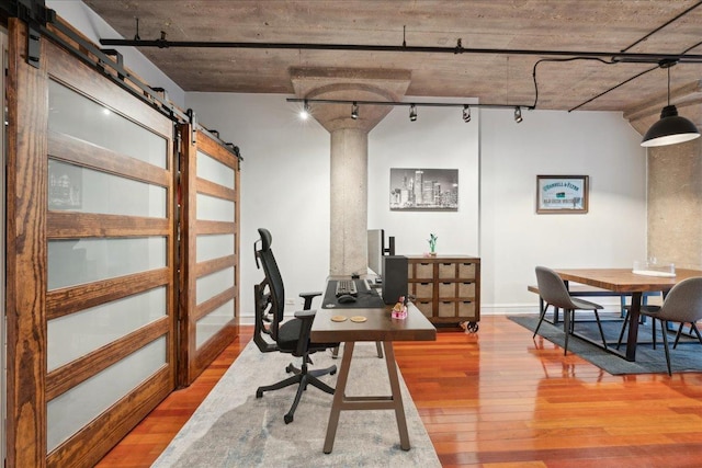 411 W Ontario St Unit 411, Chicago, IL 60654 - home office featuring light wood finished floors, a barn door, and rail lighting