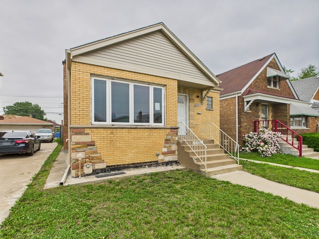 3810 W 71st St, Chicago, IL 60629 - bungalow-style home with brick siding, a front yard, and entry steps