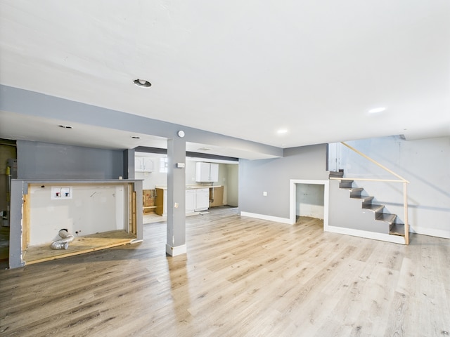 3810 W 71st St, Chicago, IL 60629 - unfurnished living room with light wood-type flooring, stairway, and recessed lighting
