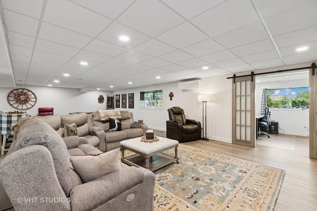 2032 Wentworth Dr, Volo, IL 60020 - living room with a barn door, a wall unit AC, light wood finished floors, recessed lighting, and healthy amount of natural light
