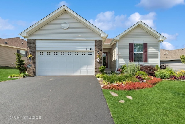 2032 Wentworth Dr, Volo, IL 60020 - ranch-style house with driveway, a front yard, an attached garage, and brick siding