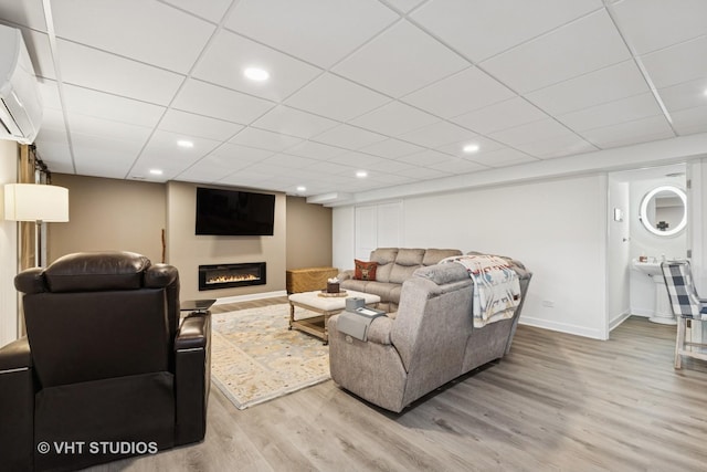 2032 Wentworth Dr, Volo, IL 60020 - living room featuring wood finished floors, a glass covered fireplace, a drop ceiling, and recessed lighting