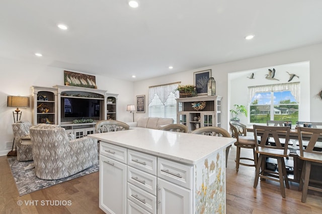 2032 Wentworth Dr, Volo, IL 60020 - kitchen featuring open floor plan, white cabinets, wood finished floors, a kitchen island, and recessed lighting