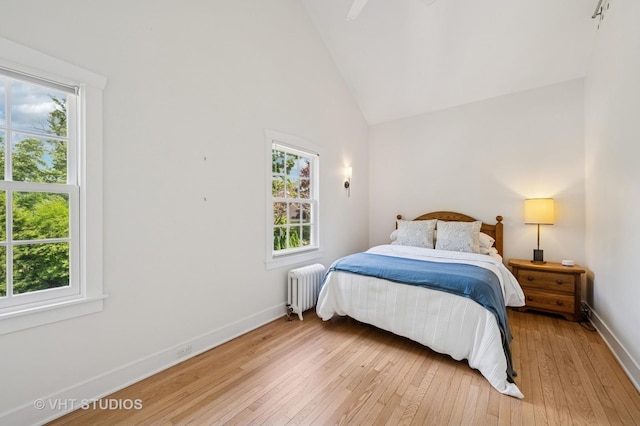 720 Willow Rd, Winnetka, IL 60093 - bedroom with radiator heating unit, multiple windows, light wood finished floors, and high vaulted ceiling