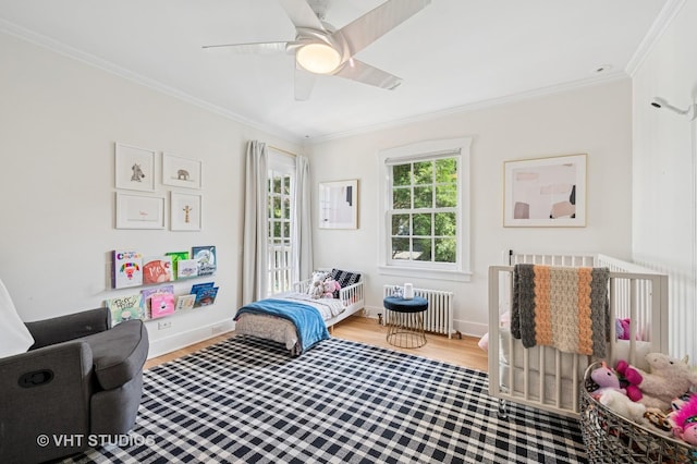 720 Willow Rd, Winnetka, IL 60093 - bedroom featuring radiator, crown molding, wood finished floors, and a ceiling fan