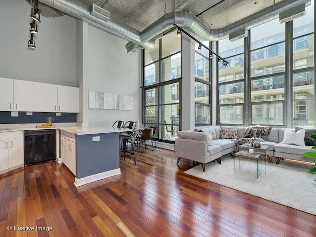 900 N Kingsbury St Unit 967, Chicago, IL 60610 - kitchen featuring dishwasher, a high ceiling, dark wood finished floors, expansive windows, and light countertops