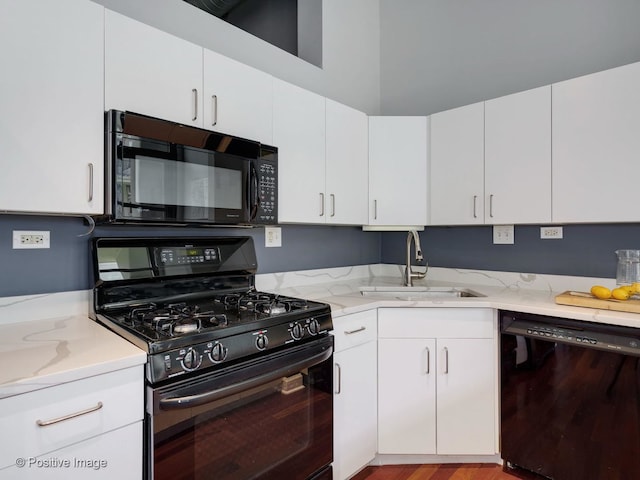 900 N Kingsbury St Unit 967, Chicago, IL 60610 - kitchen with black appliances, white cabinetry, and light wood-type flooring