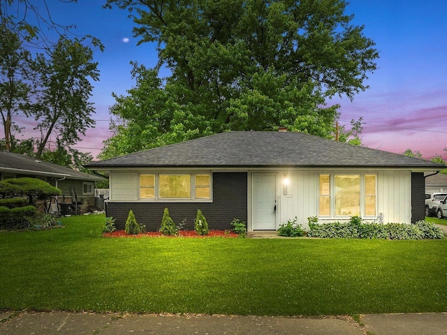 329 Blackhawk Dr, Park Forest, IL 60466 - view of front facade featuring a front lawn, brick siding, and roof with shingles