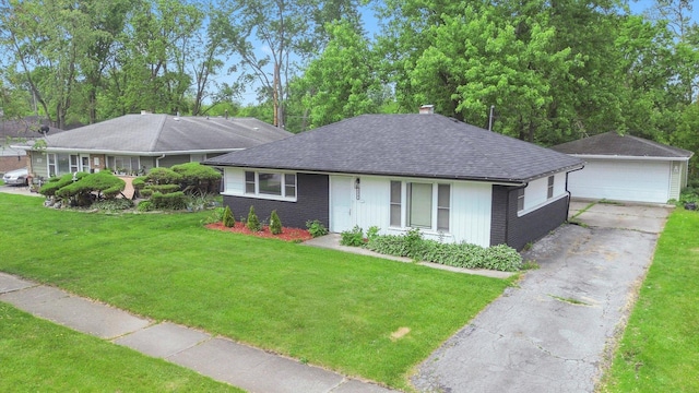 329 Blackhawk Dr, Park Forest, IL 60466 - ranch-style house featuring a detached garage, roof with shingles, brick siding, a front yard, and an outdoor structure