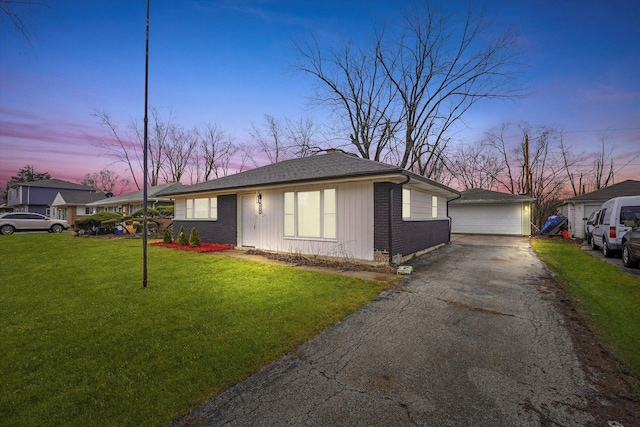 329 Blackhawk Dr, Park Forest, IL 60466 - view of front of house with a detached garage, a yard, an outdoor structure, and brick siding