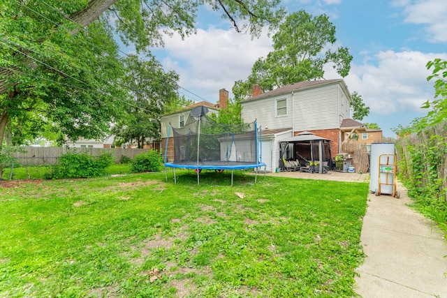 759 Norfolk Ave, Westchester, IL 60154 - rear view of house with a trampoline, a gazebo, a fenced backyard, a patio area, and brick siding