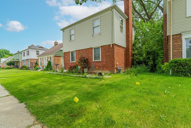 759 Norfolk Ave, Westchester, IL 60154 - view of front of property featuring a chimney, brick siding, and a front lawn