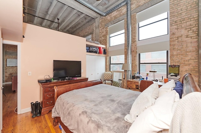2545 S Dearborn St Unit 323, Chicago, IL 60616 - bedroom featuring high vaulted ceiling, wood finished floors, and a closet