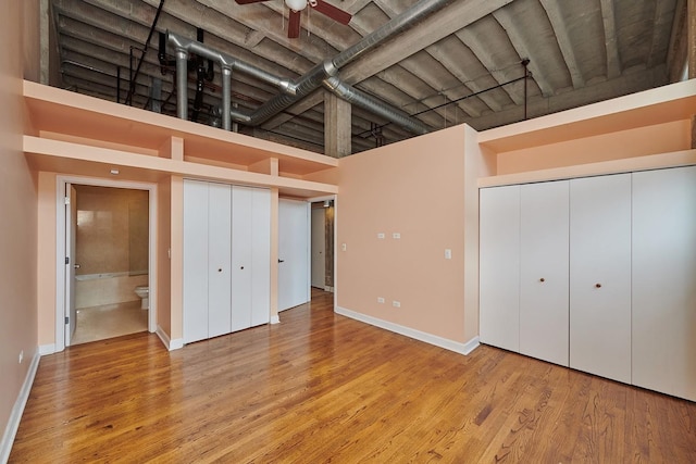 2545 S Dearborn St Unit 323, Chicago, IL 60616 - unfurnished bedroom with a towering ceiling, wood finished floors, and a closet