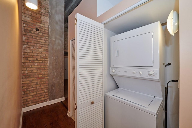2545 S Dearborn St Unit 323, Chicago, IL 60616 - washroom with stacked washing machine and dryer, wood finished floors, and brick wall