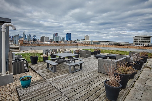 2545 S Dearborn St Unit 323, Chicago, IL 60616 - wooden terrace with a view of skyline and outdoor dining space