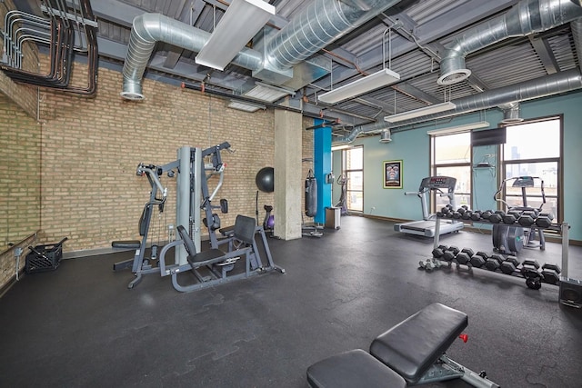 2545 S Dearborn St Unit 323, Chicago, IL 60616 - workout area with baseboards and brick wall
