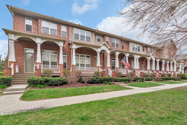 1109 Longwood Dr, Lisle, IL 60532 - townhome / multi-family property with covered porch, brick siding, and a front yard