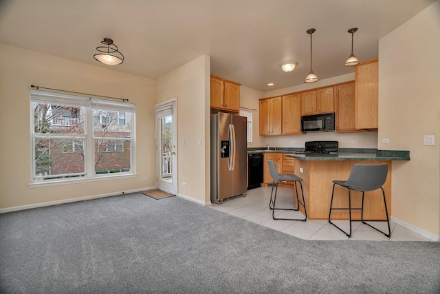 1109 Longwood Dr, Lisle, IL 60532 - kitchen featuring black appliances, a peninsula, dark countertops, light carpet, and pendant lighting