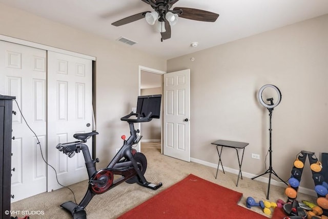 workout room with carpet and ceiling fan