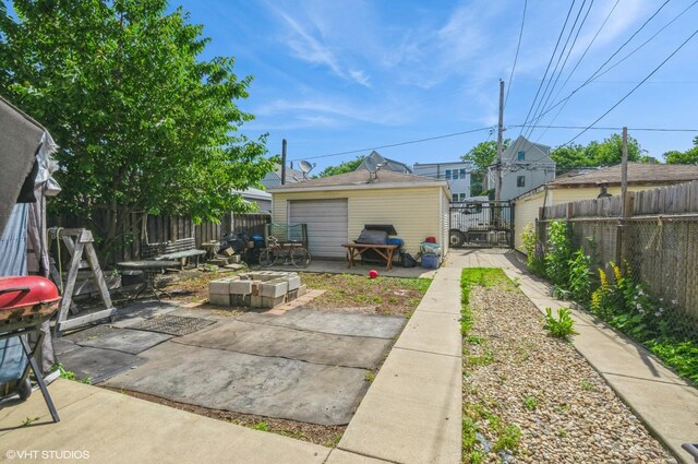 2939 N Springfield Ave, Chicago, IL 60618 - fenced backyard with an outdoor fire pit and a patio area
