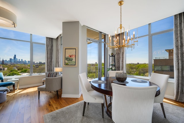 540 W Webster Ave Unit 611, Chicago, IL 60614 - dining space with hardwood / wood-style flooring, a chandelier, and a skyline view