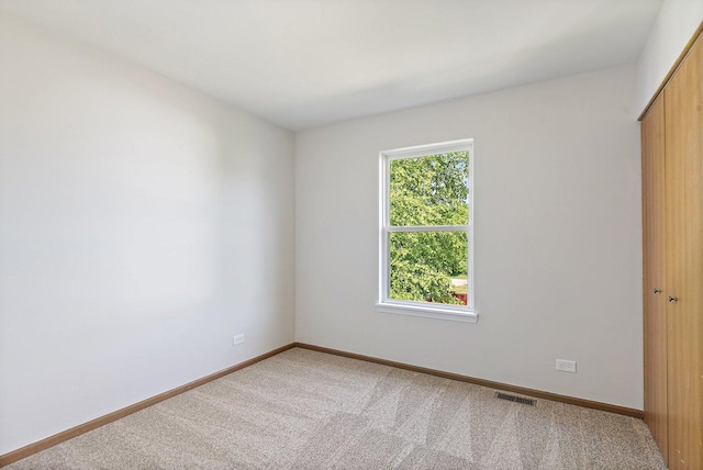 2315 Woodside Dr, Carpentersville, IL 60110 - unfurnished bedroom featuring a closet and light colored carpet