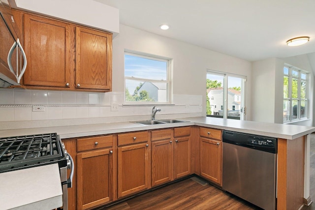 2315 Woodside Dr, Carpentersville, IL 60110 - kitchen featuring stainless steel appliances, a peninsula, tasteful backsplash, dark wood-style flooring, and light countertops