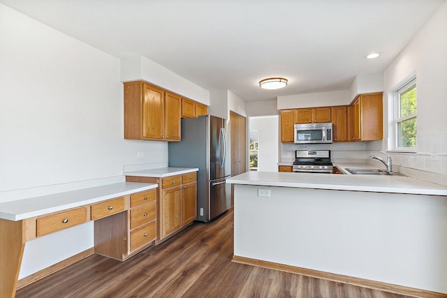 2315 Woodside Dr, Carpentersville, IL 60110 - kitchen with stainless steel appliances, dark wood finished floors, light countertops, a peninsula, and brown cabinets