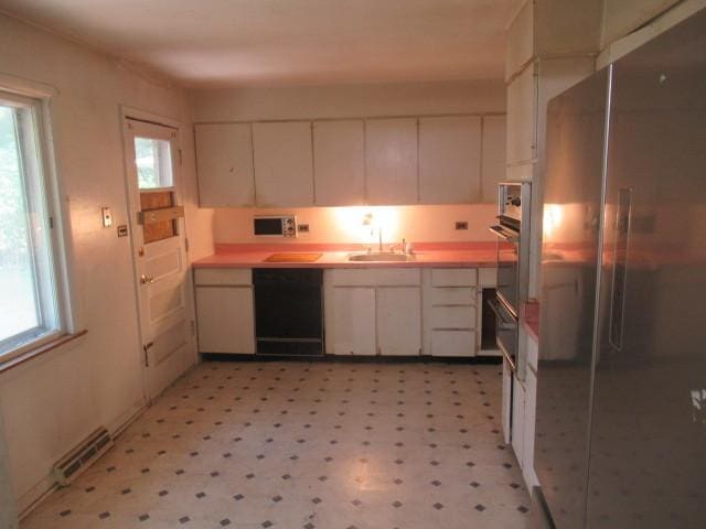 3636 Elm Ct, Flossmoor, IL 60422 - kitchen featuring appliances with stainless steel finishes, white cabinetry, light flooring, and light countertops