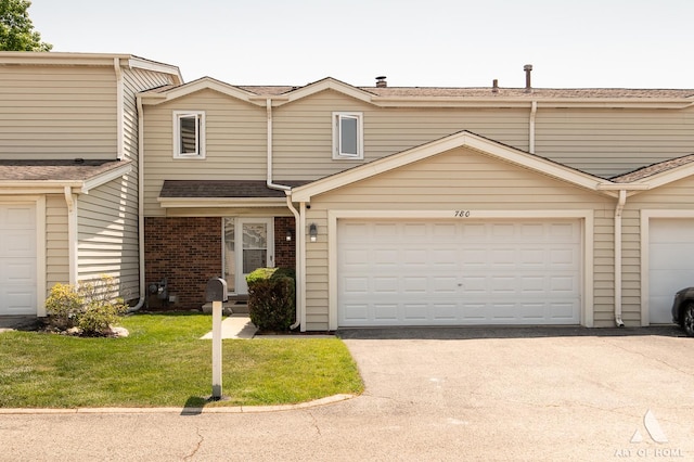 780 Buckingham Ct, Hoffman Estates, IL 60169 - townhome / multi-family property featuring brick siding, a front yard, asphalt driveway, and roof with shingles
