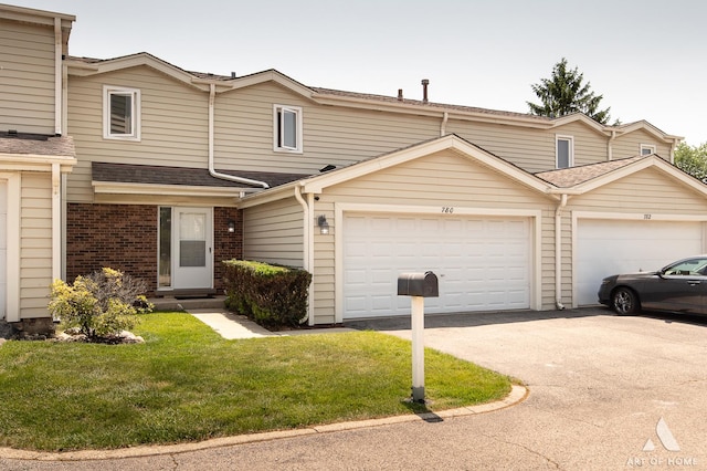 780 Buckingham Ct, Hoffman Estates, IL 60169 - multi unit property with an attached garage, asphalt driveway, a front yard, brick siding, and roof with shingles