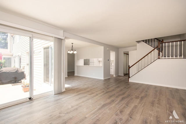 780 Buckingham Ct, Hoffman Estates, IL 60169 - unfurnished living room with a chandelier, wood finished floors, and stairs